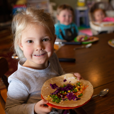Young girl with plate of colorful vegetables