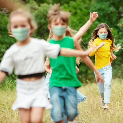 Kids running with masks on.
