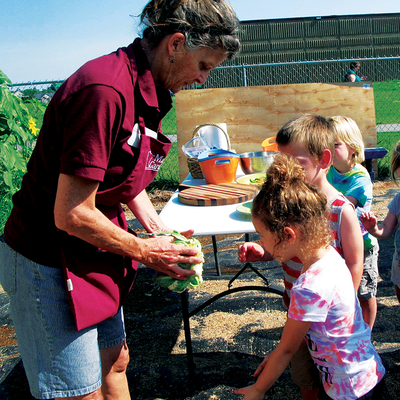 Master Gardener volunteer working with kids.