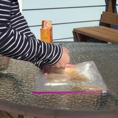A hand popping a sandwich bag.
