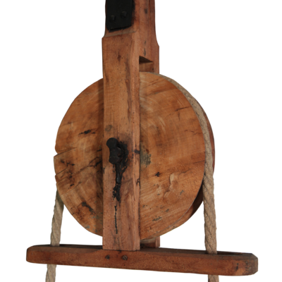 A wooden pulley with rope.