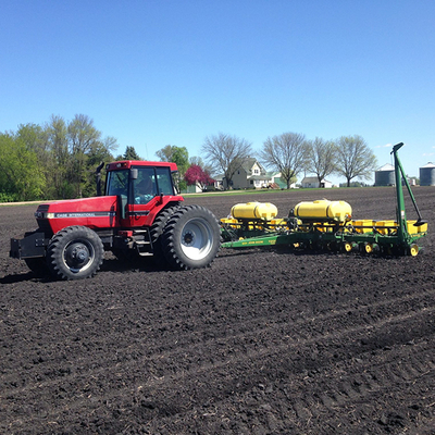 red tractor spreading fertilizer