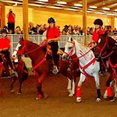 youth on horses in arena