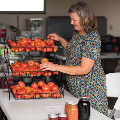Woman setting up tomato display