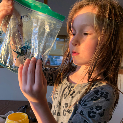 Girl mixing bioplastic in a bag.
