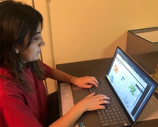 Adriana Castillo Castillo at laptop