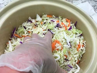 Adding salt into cabbage.