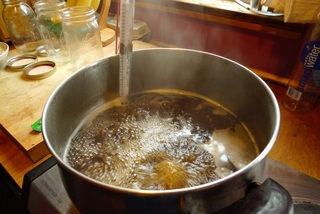 A pot of syrup for canning cooking on stove.