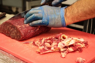 Trimming raw meat.